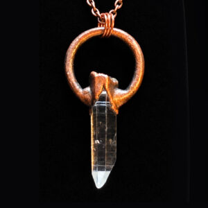 Quartz Crystal Copper Pendant in the Key to the Castle design on black velvet.