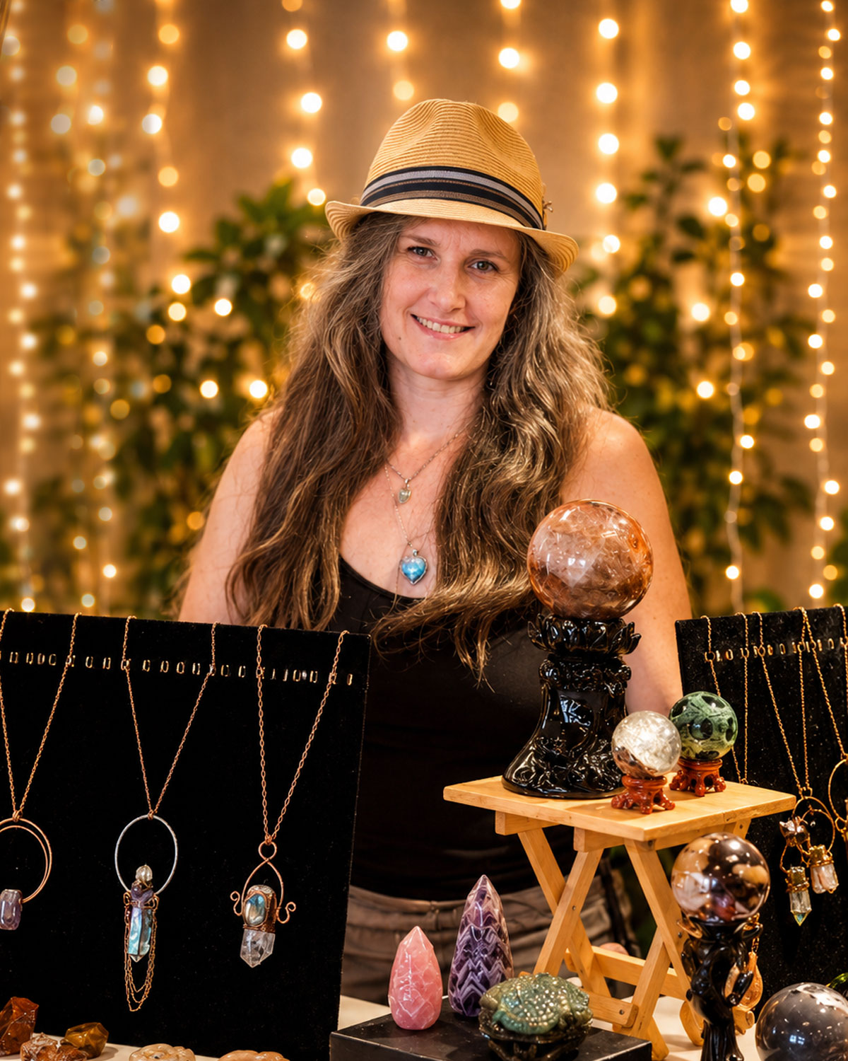 Macy Wood of Sparkling Delicious displaying handcrafted crystal jewelry and stones