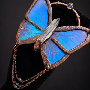 Angled view of Blue Morpho butterfly necklace with iridescent wings