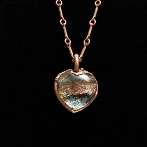 Garden quartz heart pendant in copper on black velvet